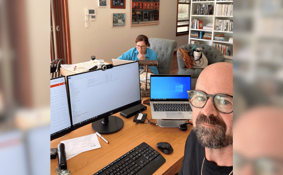 Man and woman sitting in front of computers.