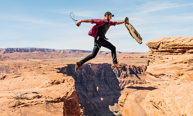 Lady jumping between rocks