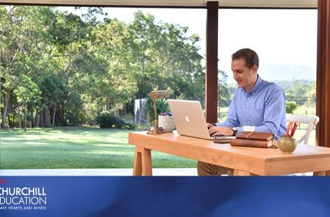 a man working at a desk on a laptop
