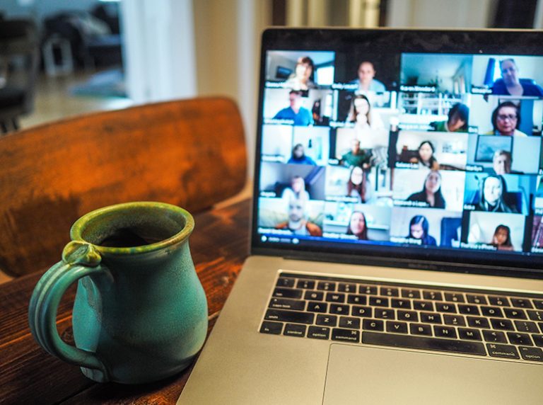 Laptop video conference call and coffee cup