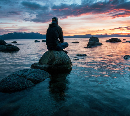 sitting on rock in lake