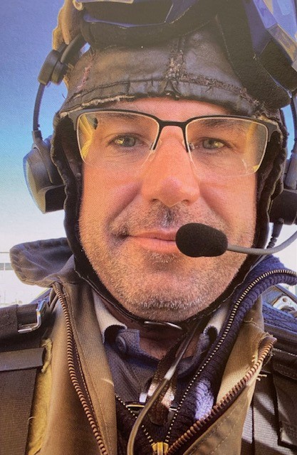 Headshot of man wearing aviation headgear. 